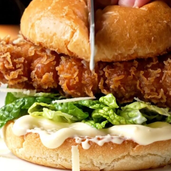 Crispy chicken Caesar sandwich with golden fried chicken, romaine, and shaved parmesan on a toasted brioche bun