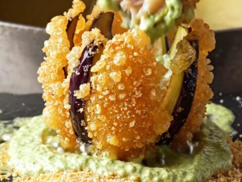 Crispy blooming eggplant fan fries with garlic lemon mint yogurt dip on a white plate