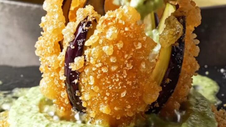 Crispy blooming eggplant fan fries with garlic lemon mint yogurt dip on a white plate