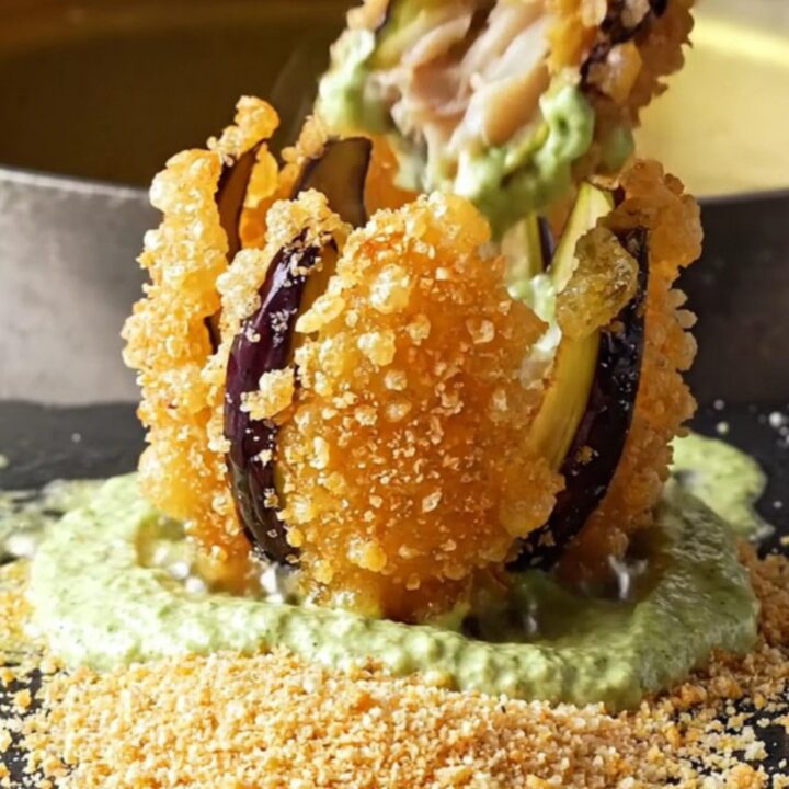 Crispy blooming eggplant fan fries with garlic lemon mint yogurt dip on a white plate