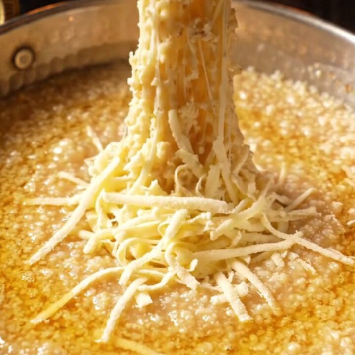 Golden Black Sea kuymak in a copper pan with melted cheese pull