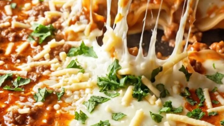 A bubbling skillet of lasagna with melted mozzarella and a lifted cheesy slice