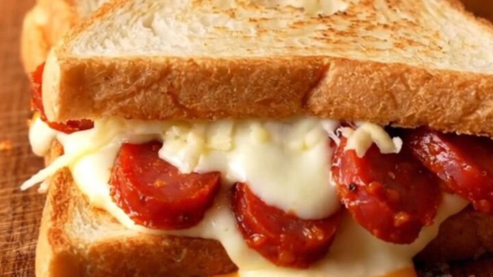 Crispy triangle toast sandwich cut open showing melted mozzarella and sucuk