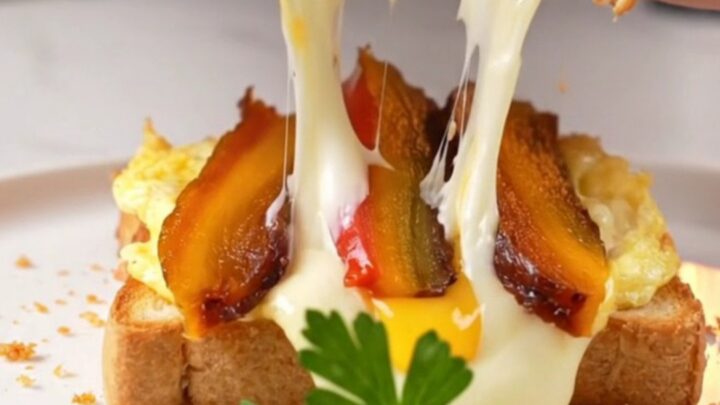 Golden crispy toast sandwich cut in half with molten cheese pull