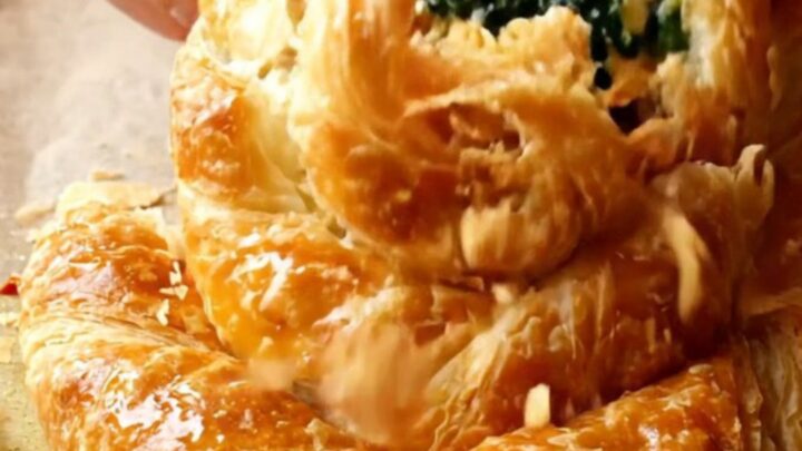 Golden spiral rose börek with spinach and feta on a baking sheet