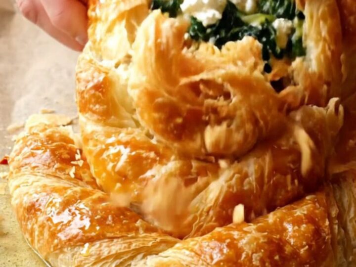 Golden spiral rose börek with spinach and feta on a baking sheet