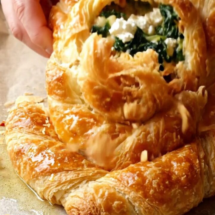 Golden spiral rose börek with spinach and feta on a baking sheet