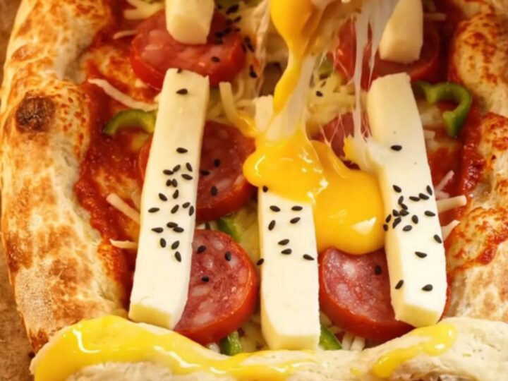 Golden lavaş pizza with stuffed cheese crust and colorful toppings