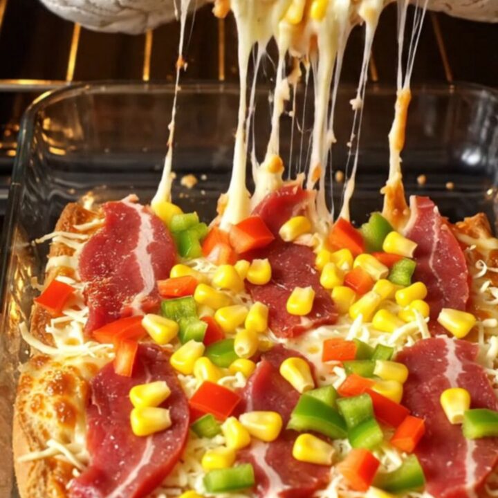 Golden toast bread pizza with melted kaşar cheese, sucuk, and corn, pulled apart showing cheese stretch