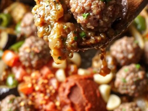 Golden seared eggplant chunks and peppers with mini meatballs in a rich tomato sauce, topped with fresh parsley