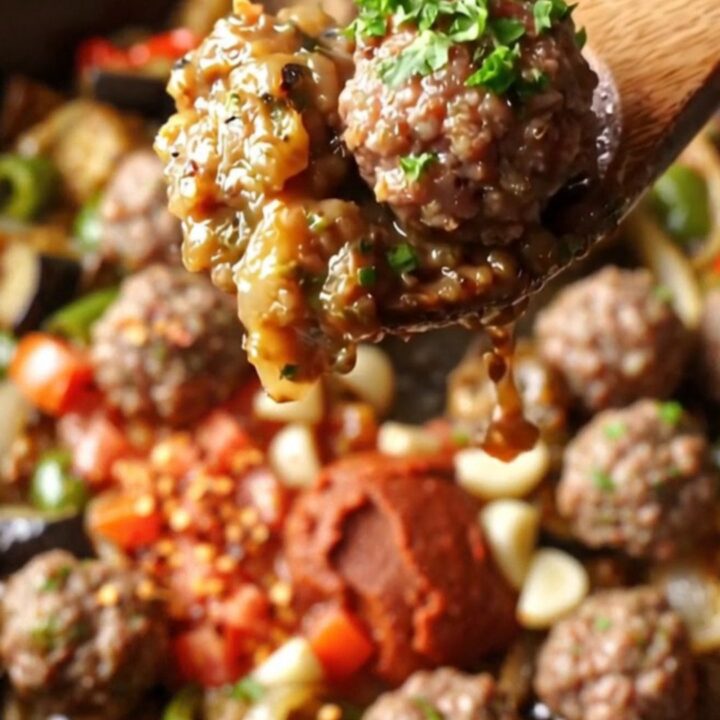 Golden seared eggplant chunks and peppers with mini meatballs in a rich tomato sauce, topped with fresh parsley