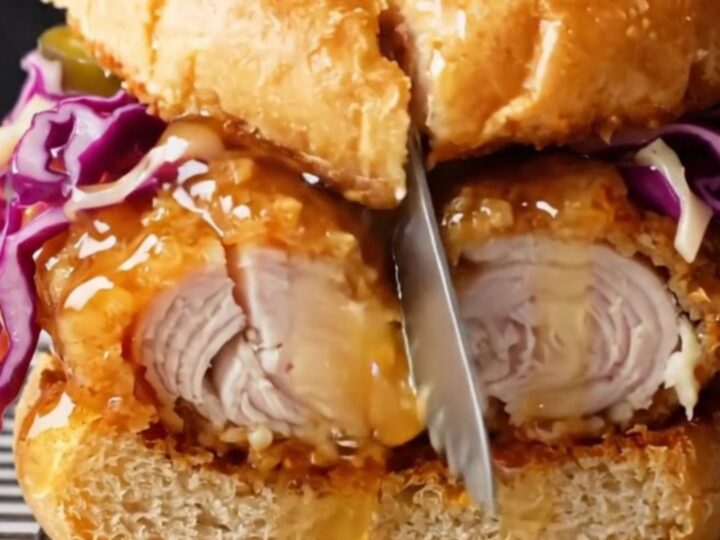 Honey butter fried chicken sandwich with pickled jalapeño slaw on a toasted brioche bun