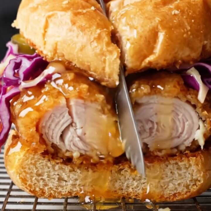 Honey butter fried chicken sandwich with pickled jalapeño slaw on a toasted brioche bun