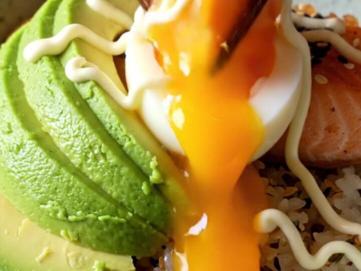 Crispy glazed salmon fillet on furikake rice with avocado and a jammy egg yolk