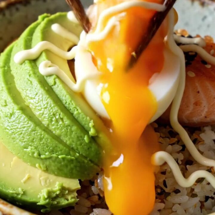 Crispy glazed salmon fillet on furikake rice with avocado and a jammy egg yolk