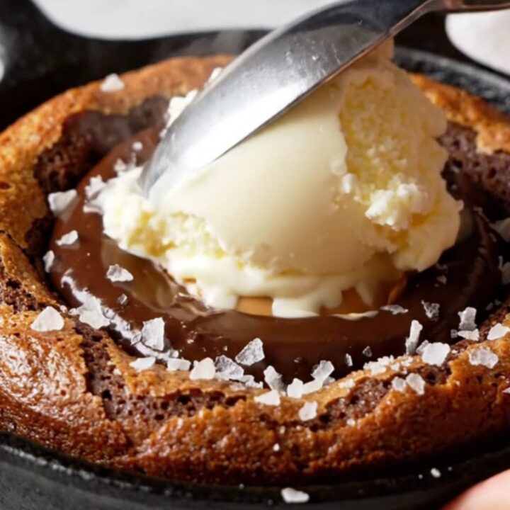 Molten chocolate peanut butter lava cake in a mini cast iron skillet with vanilla ice cream and sea salt.