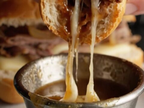 French Dip Roast Beef Skillet Sandwich with melted provolone and onion au jus for dipping