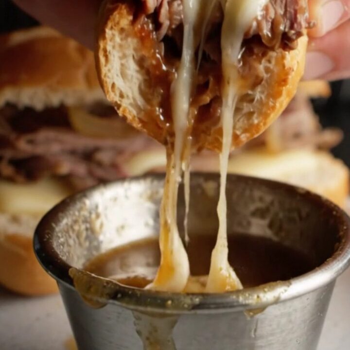 French Dip Roast Beef Skillet Sandwich with melted provolone and onion au jus for dipping