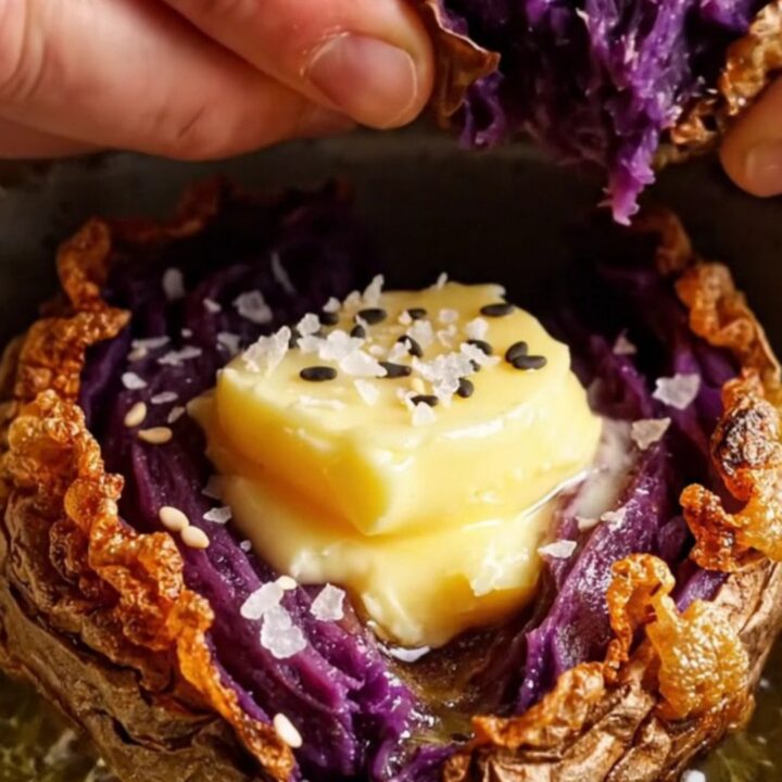 Crispy smashed purple sweet potatoes with melted miso garlic butter and sesame seeds