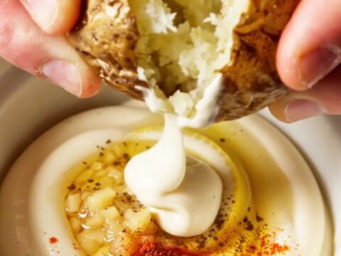 Crispy smashed red potatoes with truffle garlic aioli, golden and craggy on a platter.