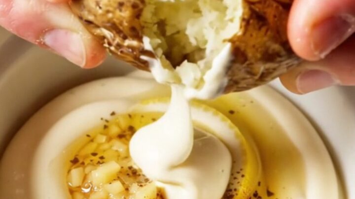 Crispy smashed red potatoes with truffle garlic aioli, golden and craggy on a platter.
