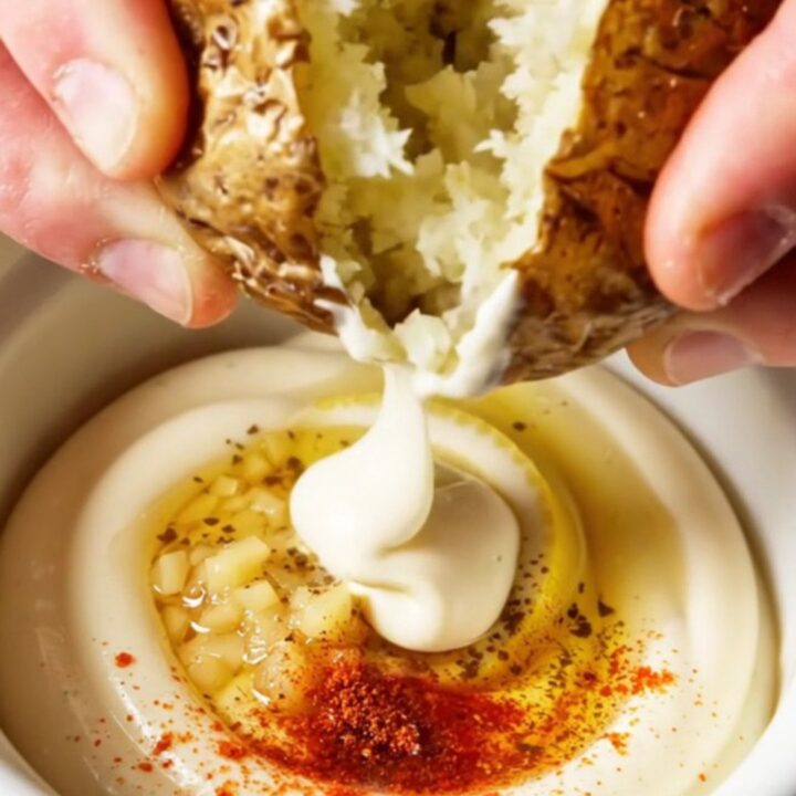 Crispy smashed red potatoes with truffle garlic aioli, golden and craggy on a platter.