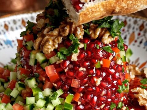 Turkish Gavurdağı salad with walnuts and pomegranate molasses in a bowl