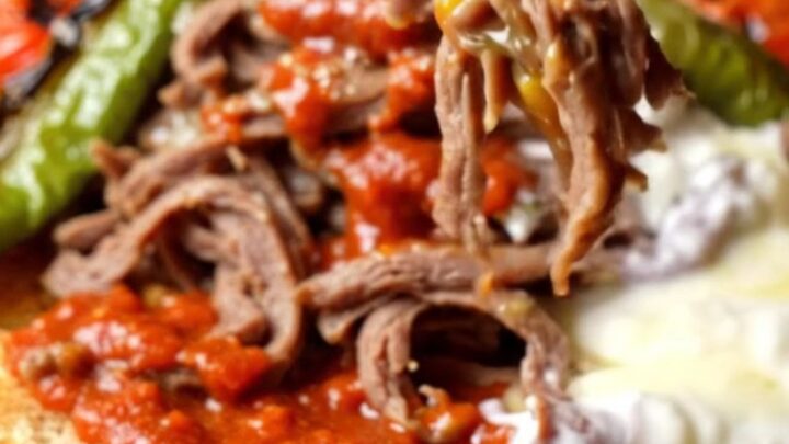 Platter of İskender kebab with shaved meat over toasted pide, tomato sauce, and foaming butter