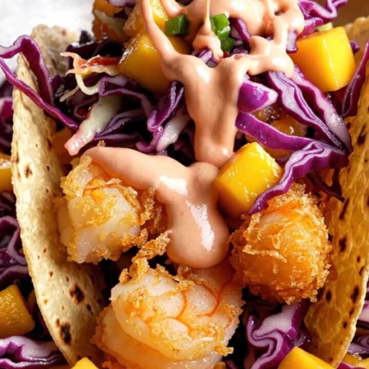Crispy Baja shrimp tacos with mango slaw and chipotle crema on corn tortillas