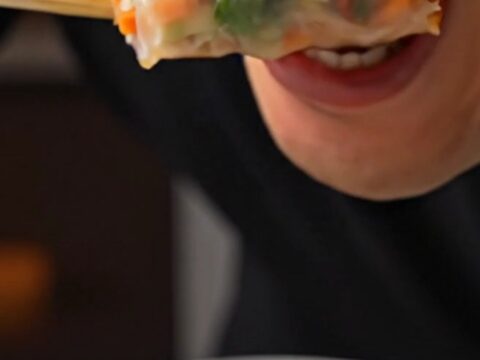 Sliced rice paper spring rolls with shrimp and purple cabbage, served with Nuoc Cham dip