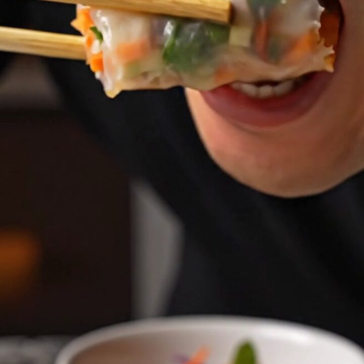 Sliced rice paper spring rolls with shrimp and purple cabbage, served with Nuoc Cham dip