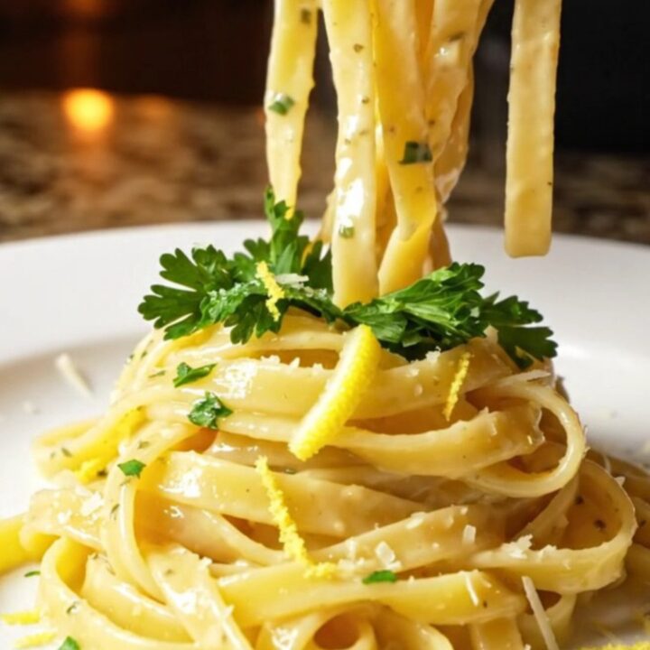 Twirled fettuccine with creamy lemon garlic sauce, topped with seared lobster chunks, parsley, and lemon zest.