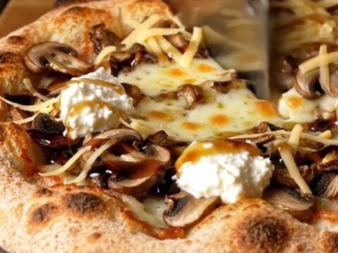 Golden sourdough flatbread topped with melted fontina, sautéed wild mushrooms, ricotta dollops