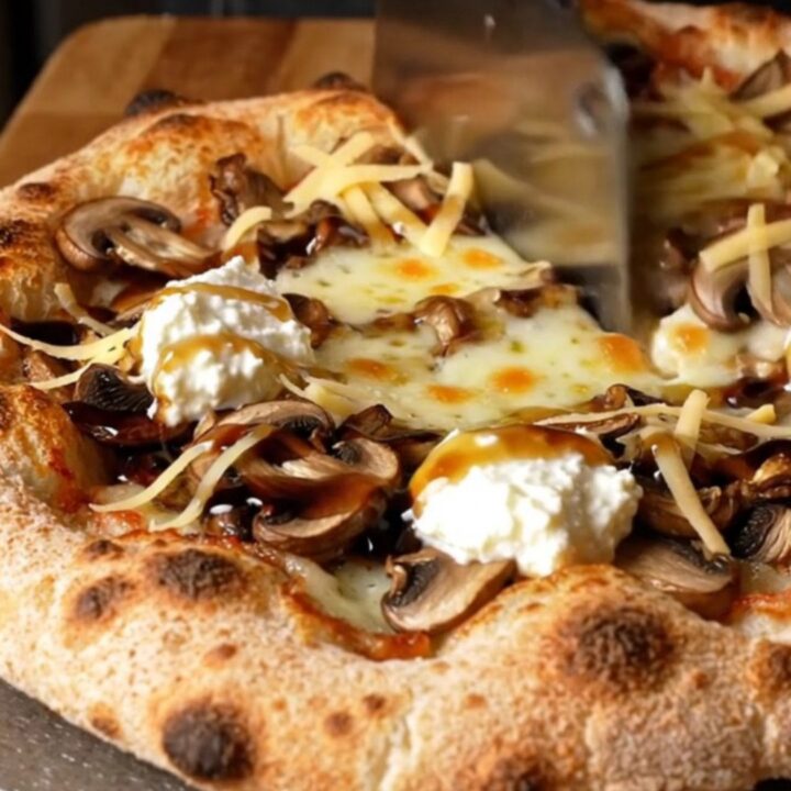 Golden sourdough flatbread topped with melted fontina, sautéed wild mushrooms, ricotta dollops