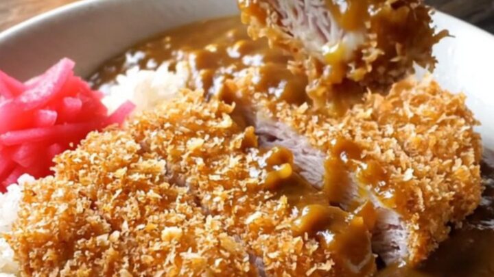 Crispy pork katsu curry bowl with rice, curry sauce, and pickled radish
