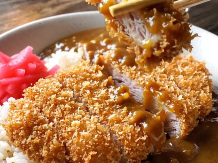 Crispy pork katsu curry bowl with rice, curry sauce, and pickled radish