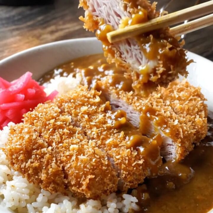 Crispy pork katsu curry bowl with rice, curry sauce, and pickled radish
