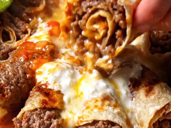 Sliced kebab rolls on a platter with yogurt, tomato sauce, and sizzling butter