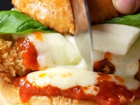 Crispy chicken Parmigiana burger with melted mozzarella and marinara on a brioche bun
