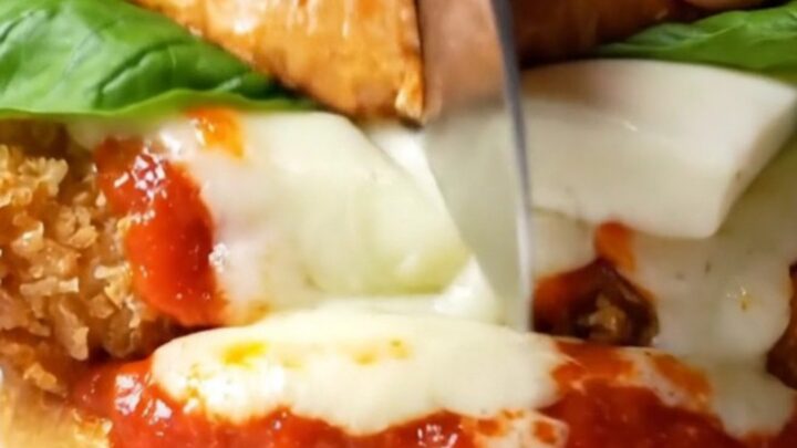 Crispy chicken Parmigiana burger with melted mozzarella and marinara on a brioche bun