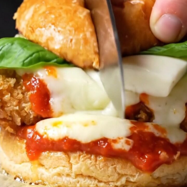 Crispy chicken Parmigiana burger with melted mozzarella and marinara on a brioche bun