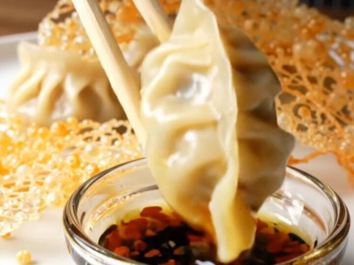 Golden lace skirt connecting crispy pork gyoza on a white platter