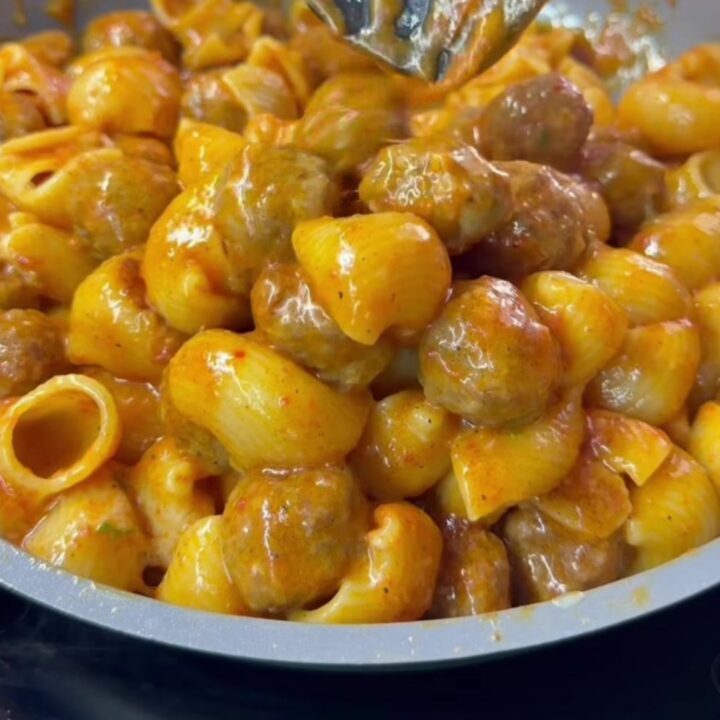 Skillet of stuffed jumbo shells with meatballs, bubbling marinara, and blistered mozzarella