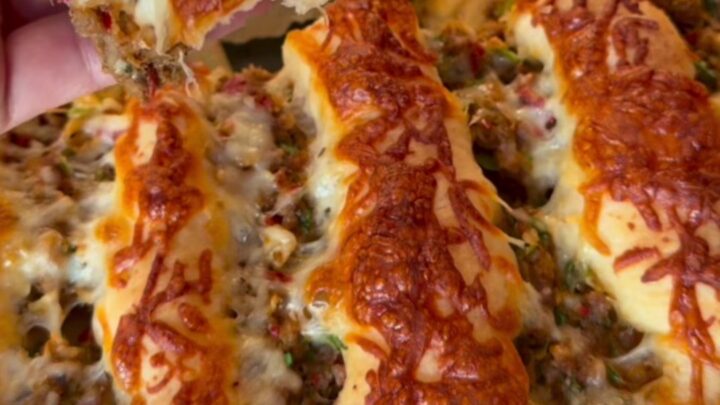 Blistered Turkish lahmacun pide with spiced beef, lemon wedges, and parsley