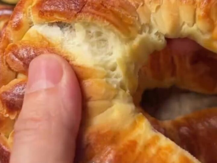 Golden braided Turkish buns with feta and herbs, showing soft, fluffy interior