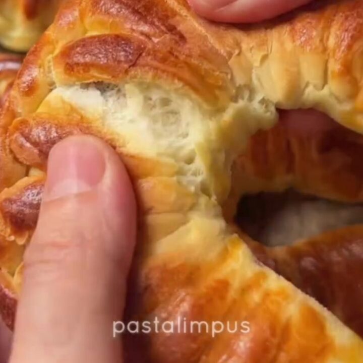 Golden braided Turkish buns with feta and herbs, showing soft, fluffy interior