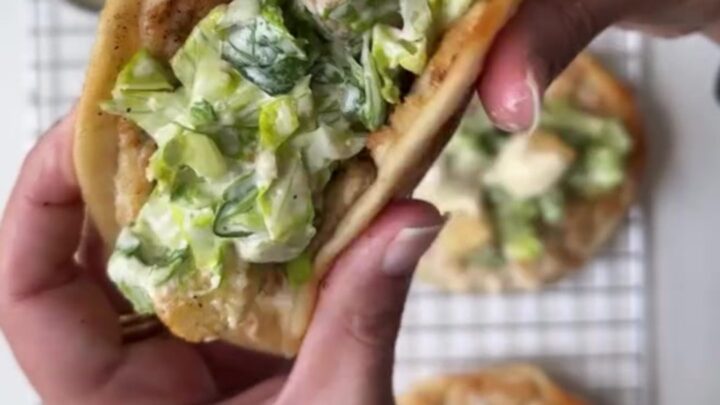 Crispy smashed chicken taco topped with Caesar salad and shaved parmesan