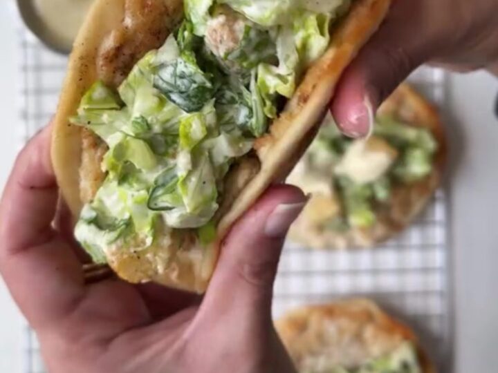 Crispy smashed chicken taco topped with Caesar salad and shaved parmesan