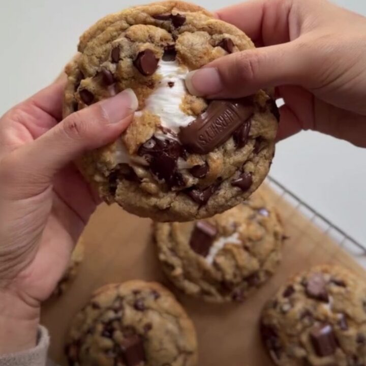 Warm s'mores cookie skillet with melted marshmallows and chocolate, sprinkled with sea salt.