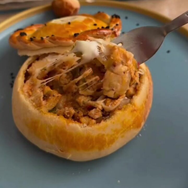 Golden bread pot casserole with bubbly mozzarella and a dough lid
